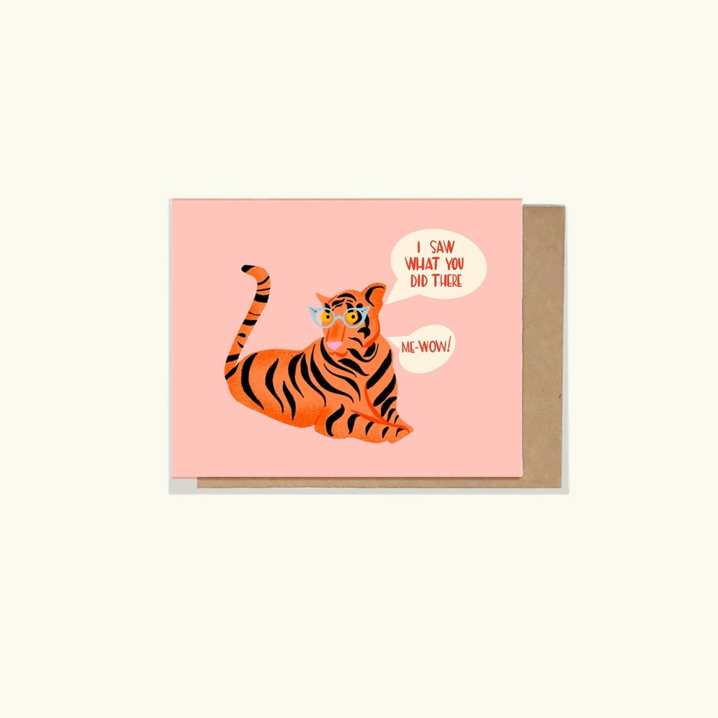 A greeting card with an illustration of a tiger wearing blue cat eye glasses, saying 'Me-Wow!' The card is pink and has a kraft envelope.

